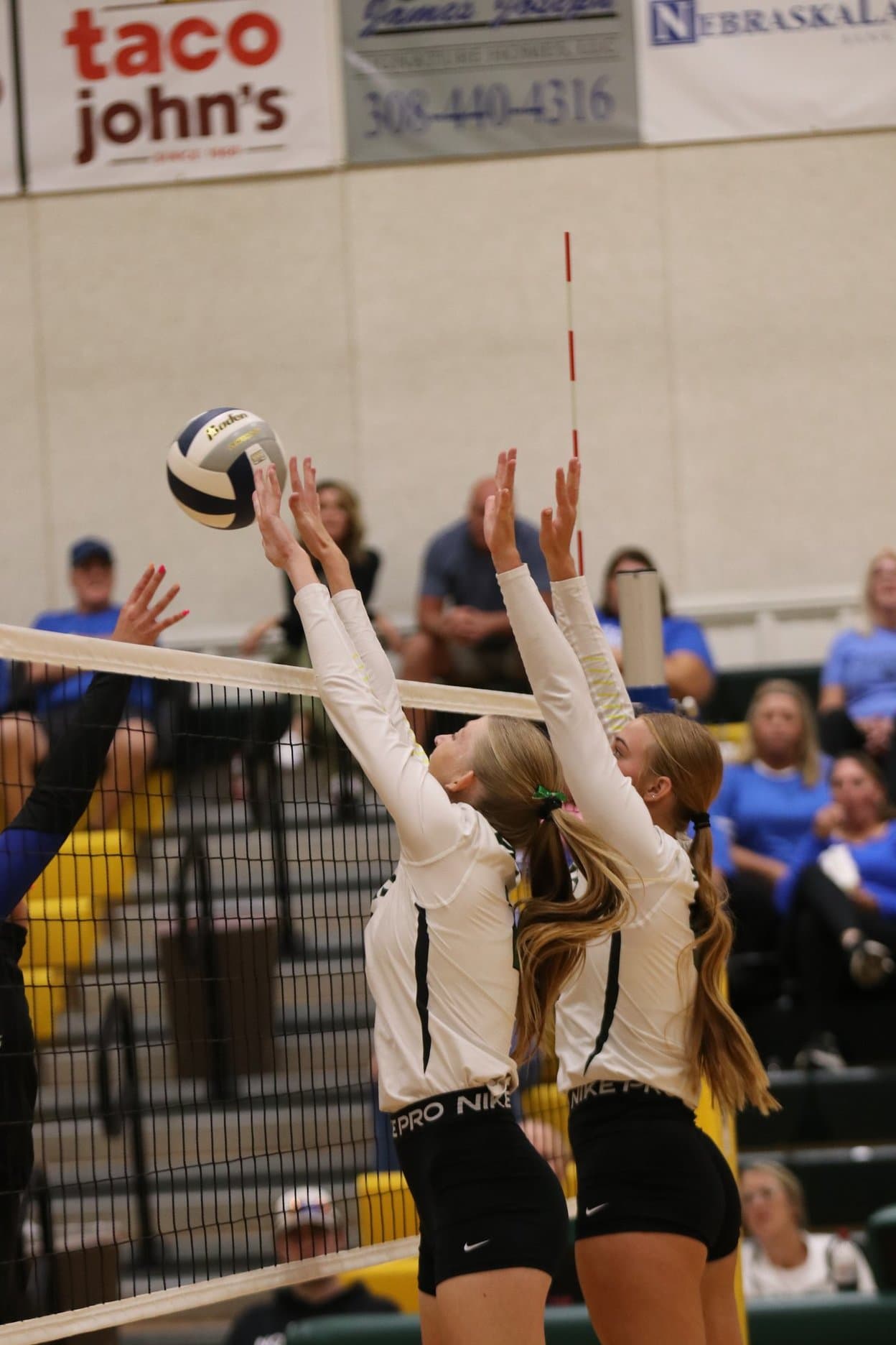 Two Stars players go up for a block at the net