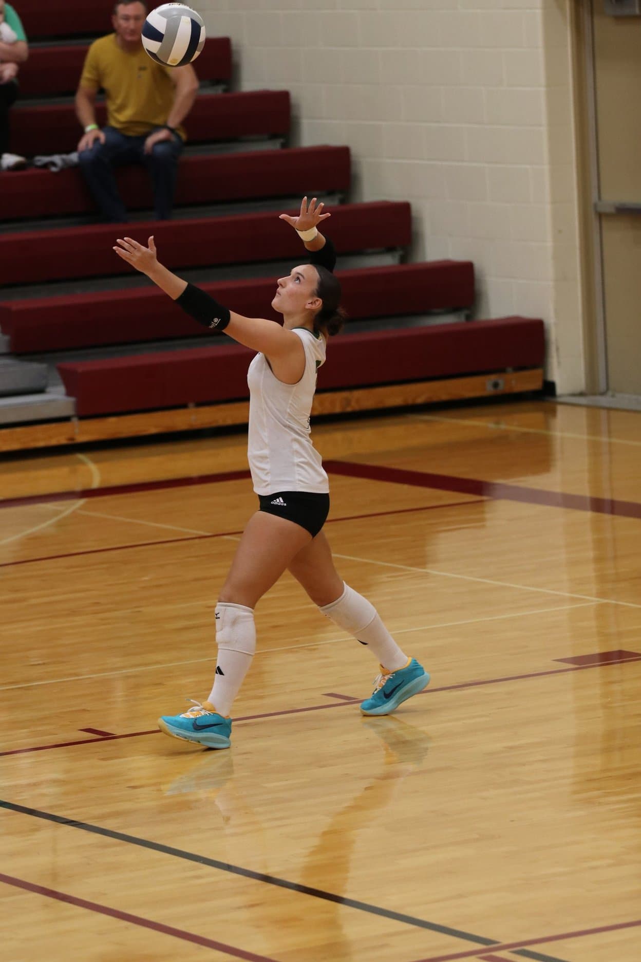 A Stars player tosses the ball to serve
